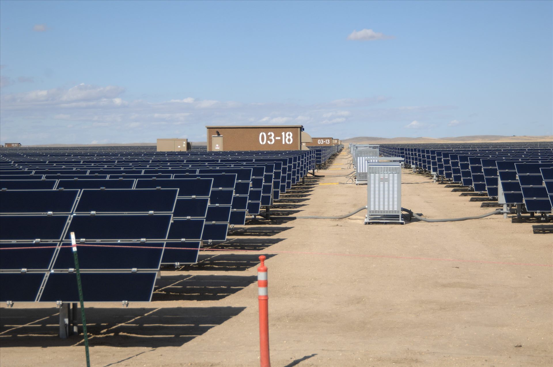 Rows of utility-scale solar panels stretching to the horizon.